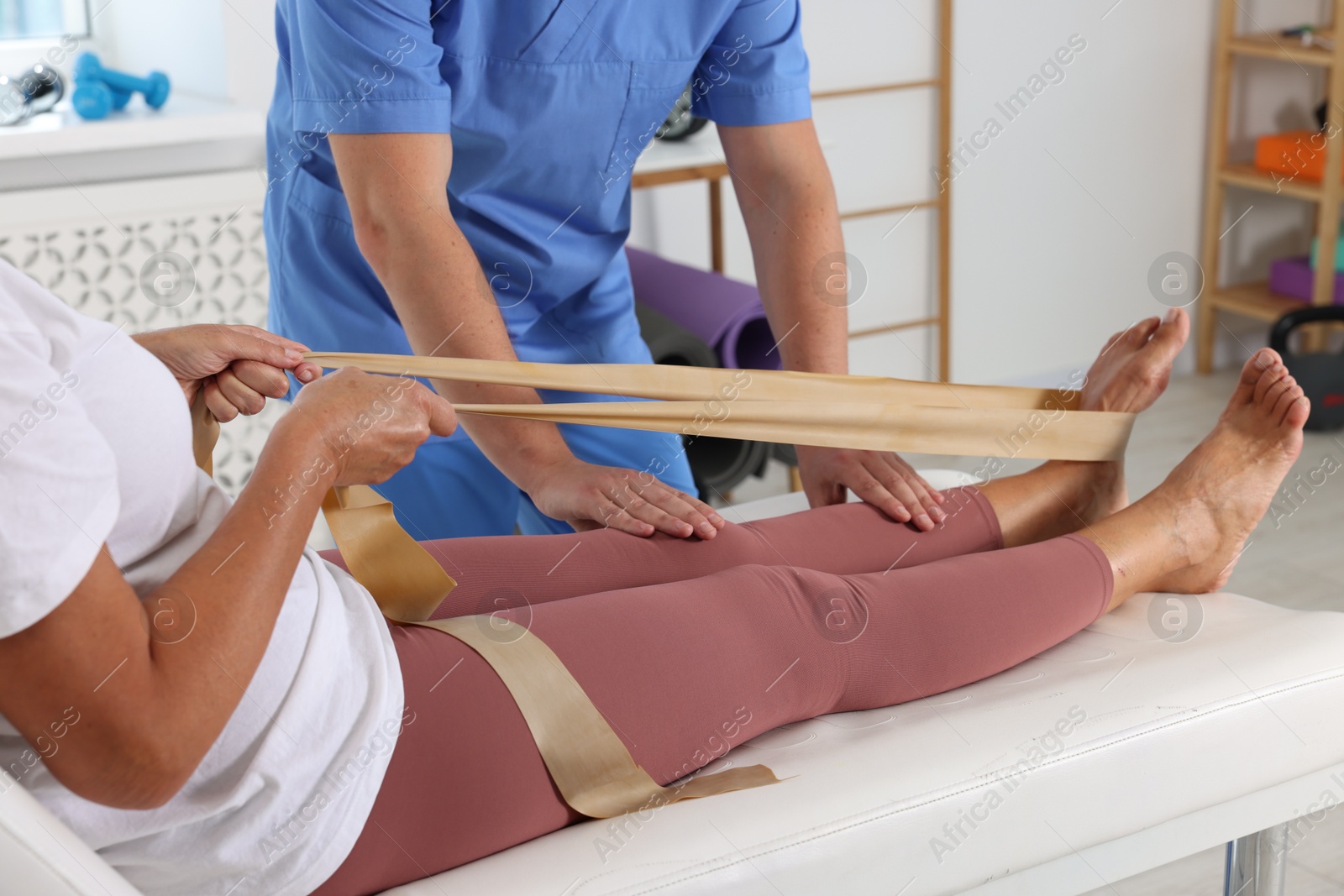 Photo of Physiotherapist working with senior patient in rehabilitation center, closeup