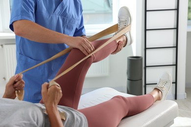 Photo of Physiotherapist working with senior patient in rehabilitation center, closeup