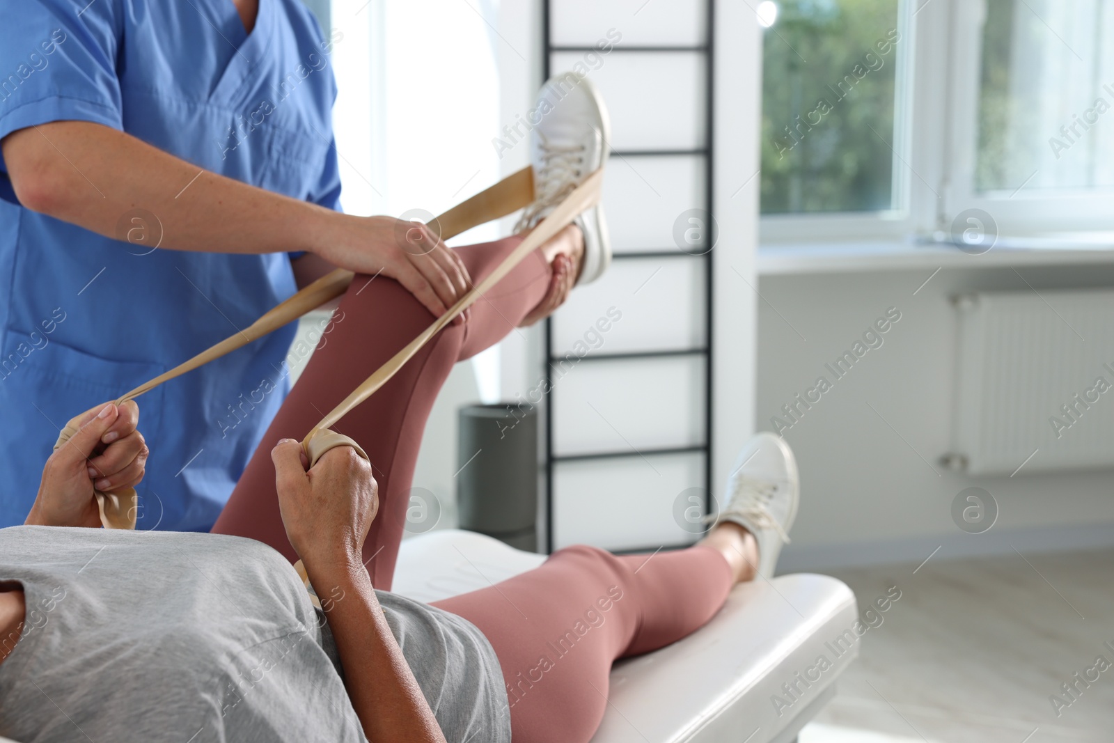 Photo of Physiotherapist working with senior patient in rehabilitation center, closeup