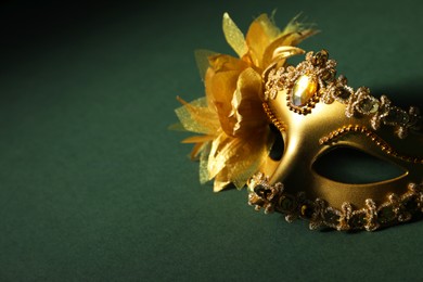 Beautiful golden carnival mask on green background. Space for text