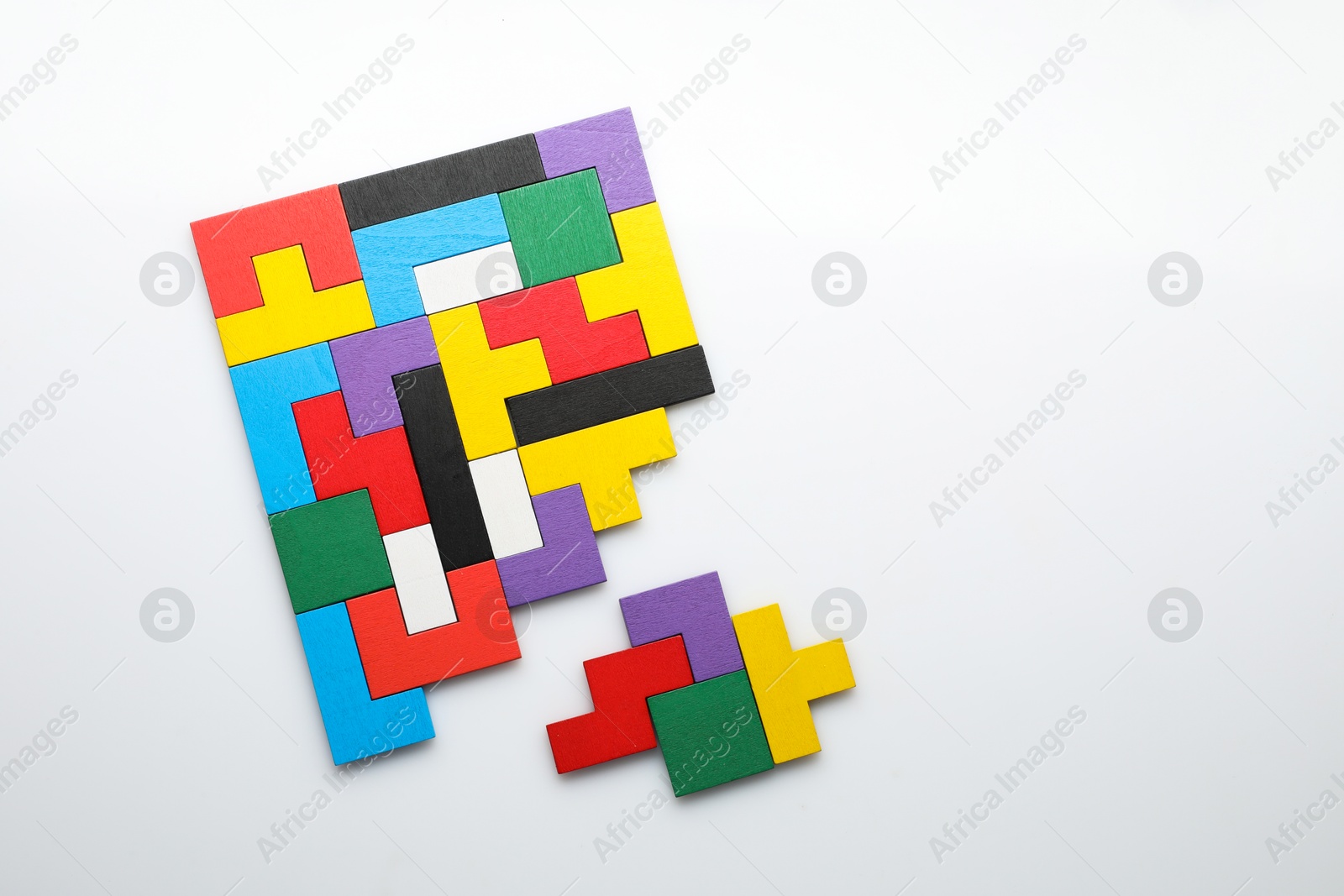 Photo of Colorful wooden puzzle pieces on white background, top view. Space for text