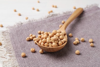 Spoon with dried peas on table, closeup