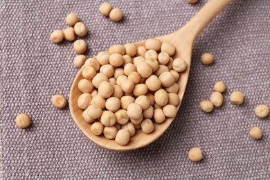 Spoon with dried peas on cloth, closeup