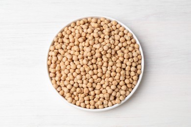 Dried peas on light wooden table, top view