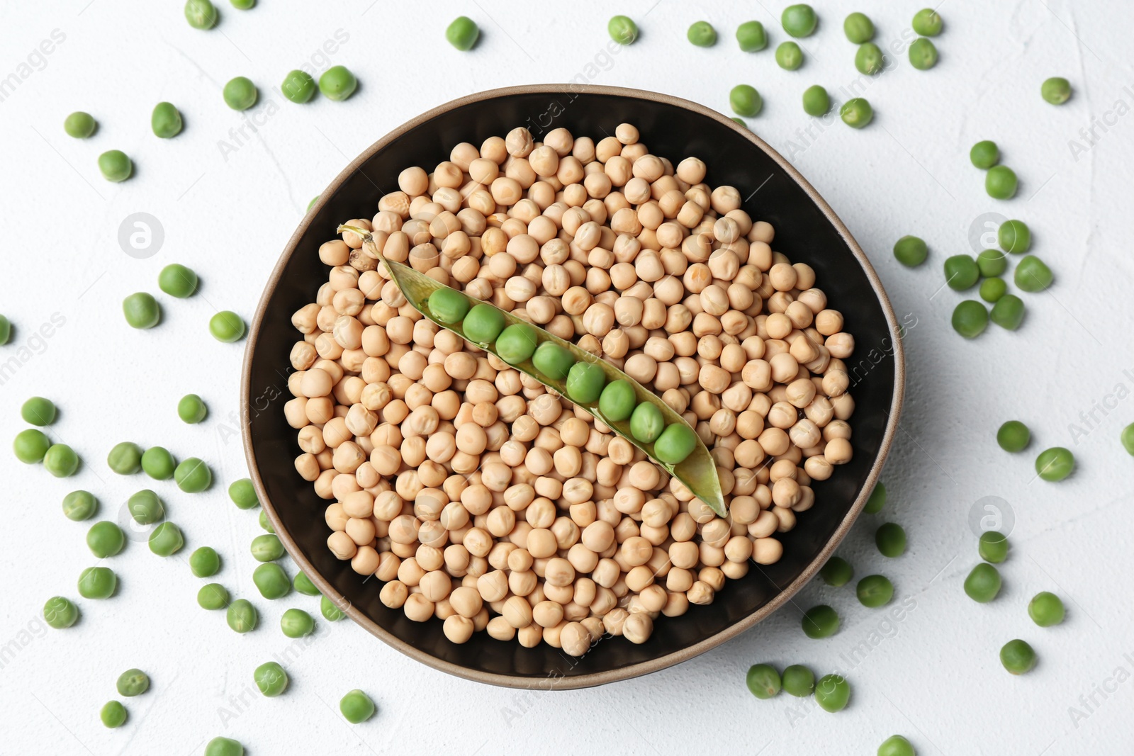 Photo of Dried peas and pod with fresh ones on white textured table, flat lay