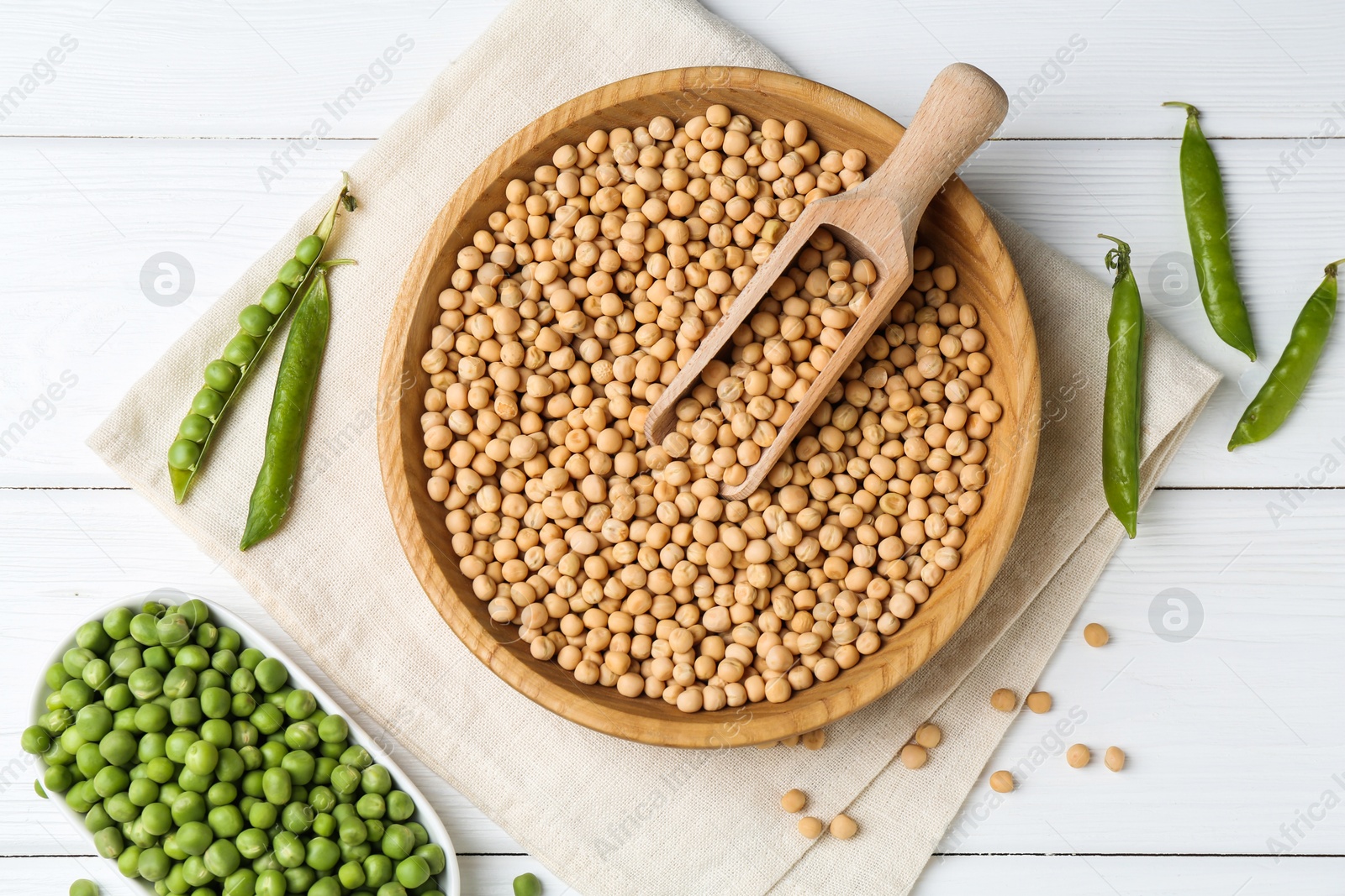 Photo of Dried peas and pods with fresh ones on white wooden table, flat lay