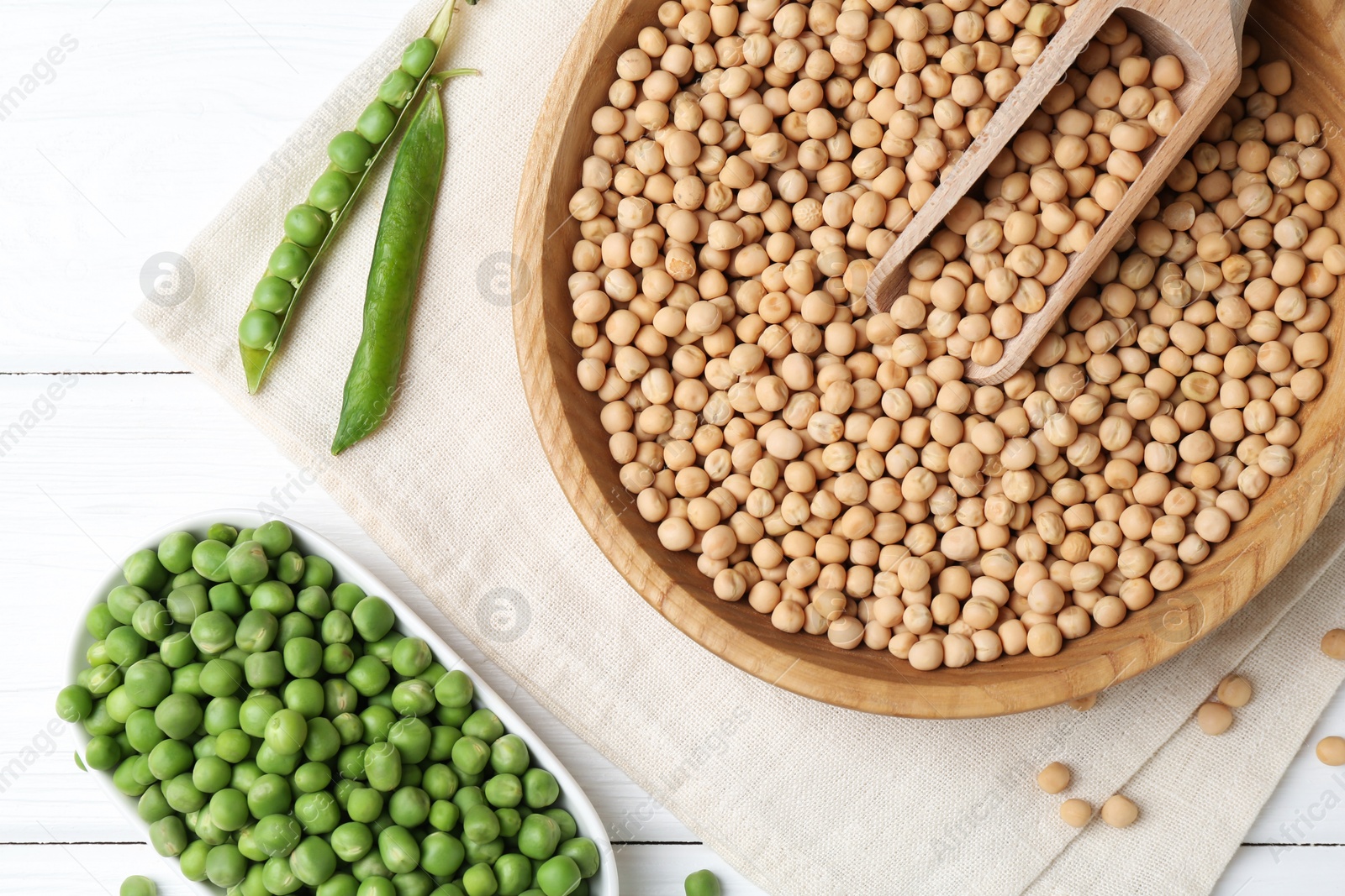 Photo of Dried peas and pods with fresh ones on white wooden table, flat lay