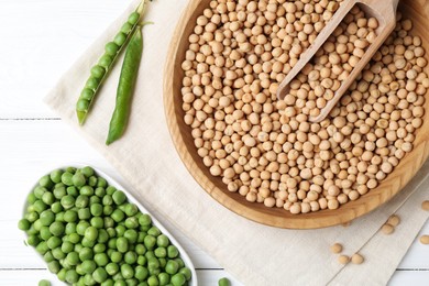 Dried peas and pods with fresh ones on white wooden table, flat lay