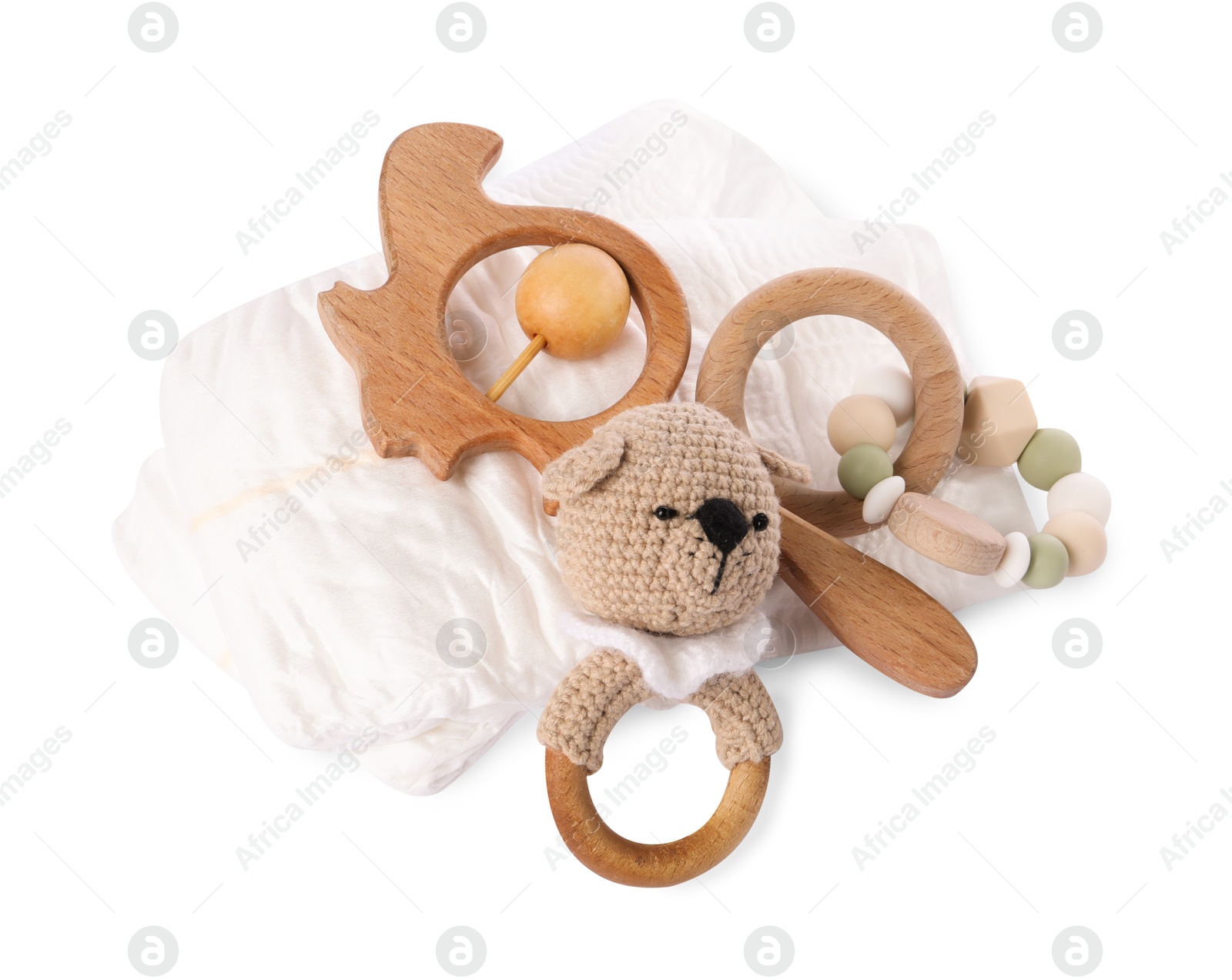 Photo of Wooden rattles and diapers isolated on white, top view. Baby accessories