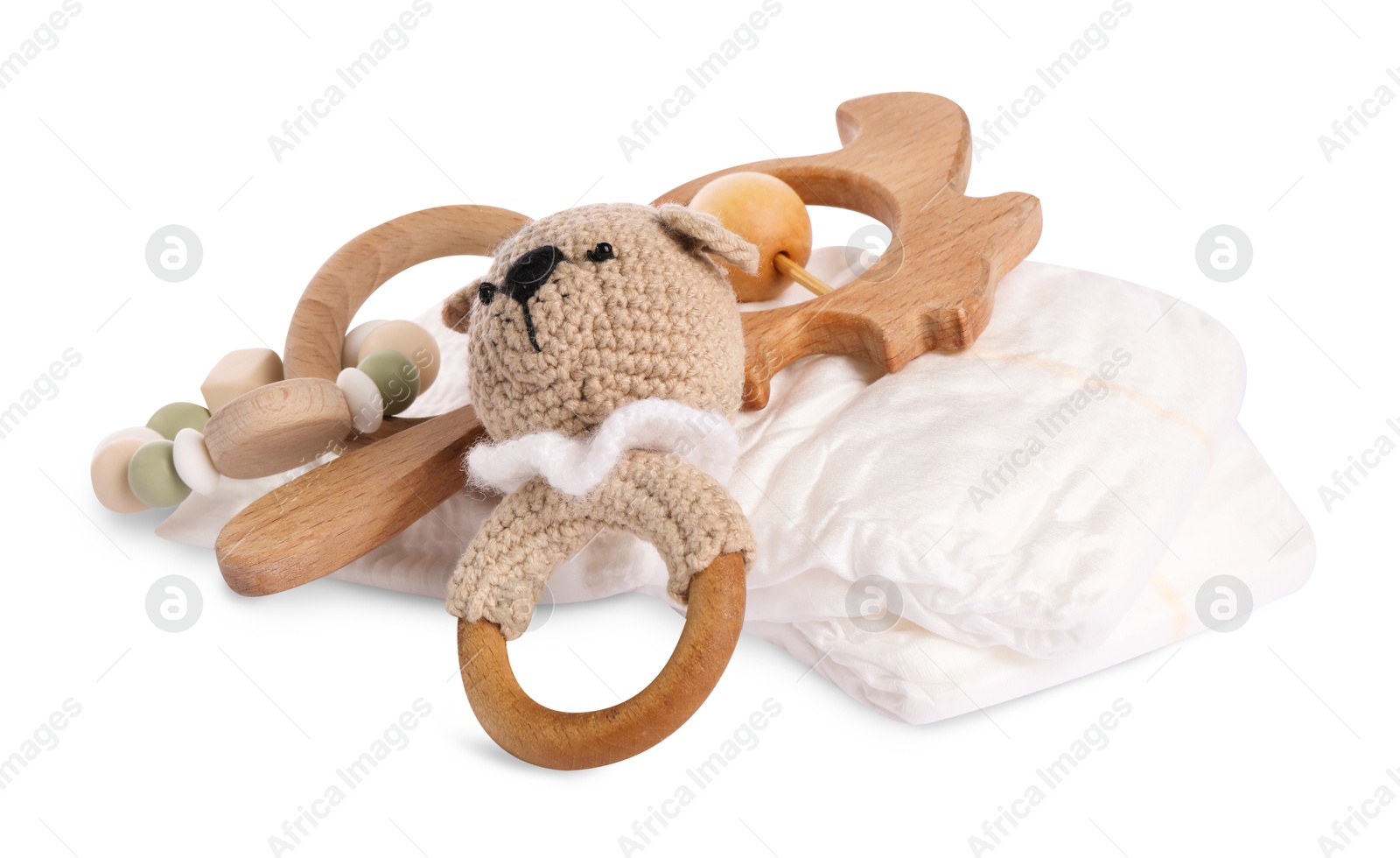 Photo of Wooden rattles and diapers isolated on white. Baby accessories