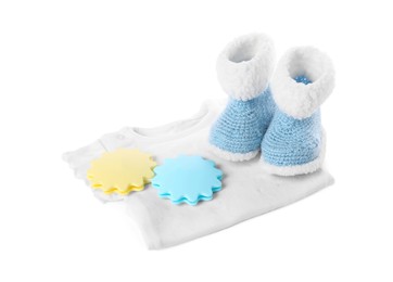 Photo of Baby toys, body and booties isolated on white