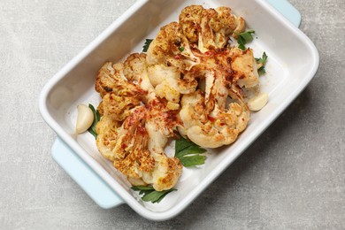 Photo of Delicious baked cauliflower steaks on grey table, top view