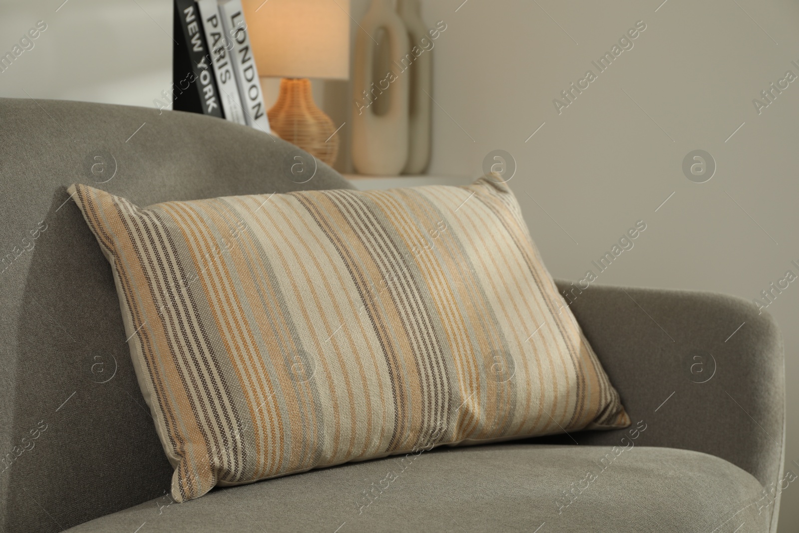 Photo of Sofa with soft cushion indoors. Interior design