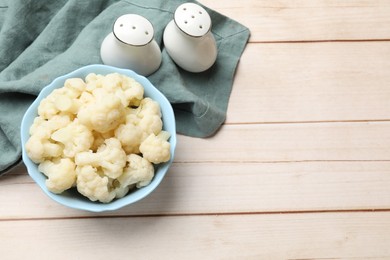 Photo of Tasty cooked cauliflower served on white wooden table, top view. Space for text