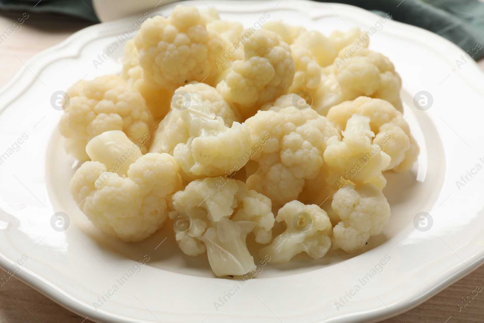 Photo of Plate with tasty cooked cauliflower on table, closeup