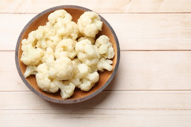 Photo of Tasty cooked cauliflower on white wooden table, top view. Space for text