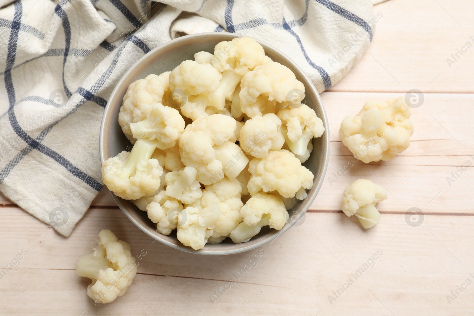 Photo of Tasty cooked cauliflower on white wooden table, top view