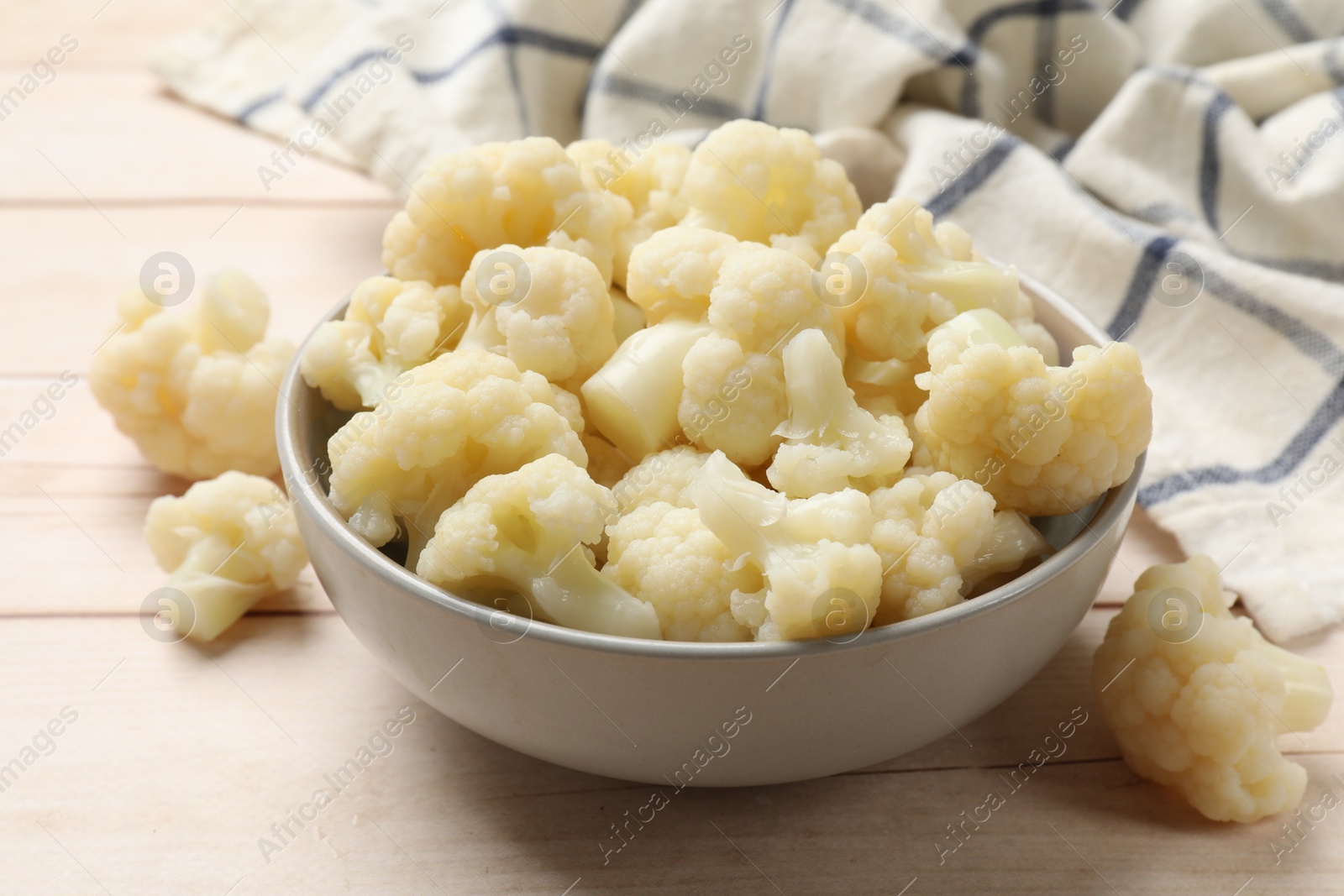 Photo of Tasty cooked cauliflower on white wooden table, closeup