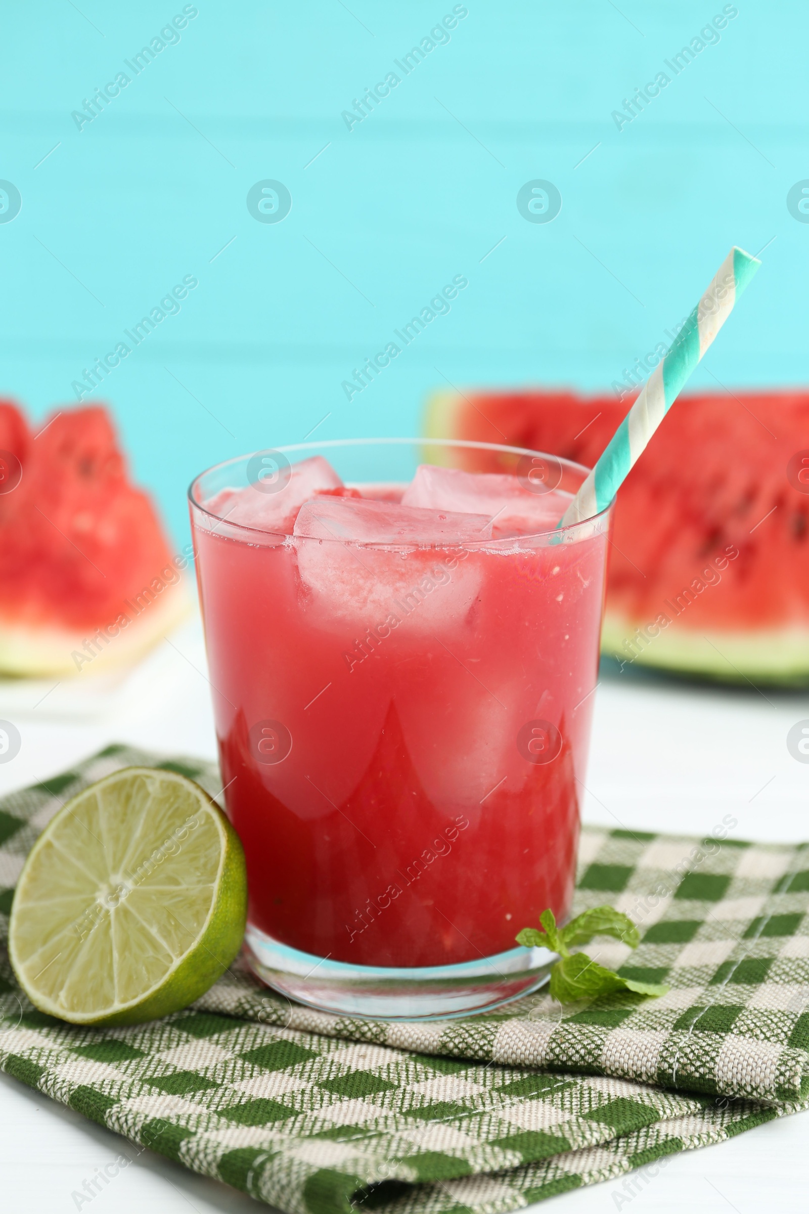 Photo of Tasty watermelon drink in glass, fresh fruits and mint on white table