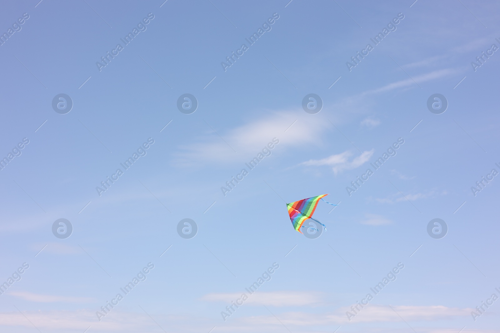 Photo of One colorful kite flying in blue sky