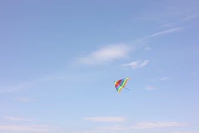 One colorful kite flying in blue sky