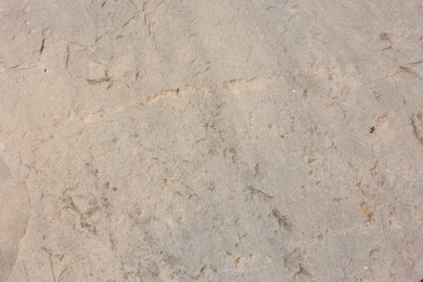 Photo of Texture of grey stone surface as background, closeup