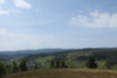 Photo of Blurred view of forest in mountains under blue sky