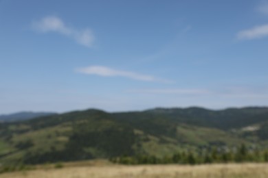 Photo of Blurred view of forest in mountains under blue sky