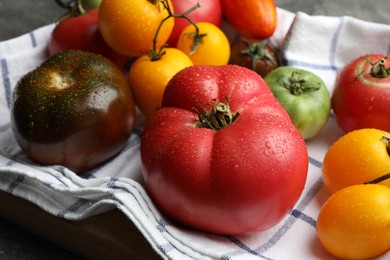 Photo of Different ripe and unripe tomatoes on table, closeup