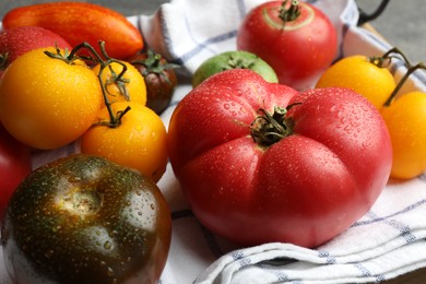 Different ripe and unripe tomatoes on table, closeup