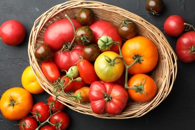 Photo of Different ripe and unripe tomatoes on grey textured table, flat lay