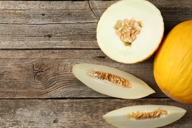 Photo of Fresh ripe melons on wooden table, flat lay. Space for text