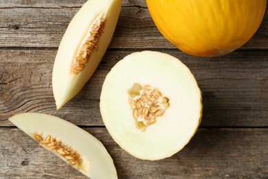 Photo of Fresh ripe melons on wooden table, flat lay