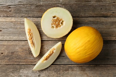 Fresh ripe melons on wooden table, flat lay