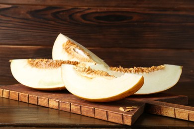 Photo of Cut fresh ripe melon on wooden table