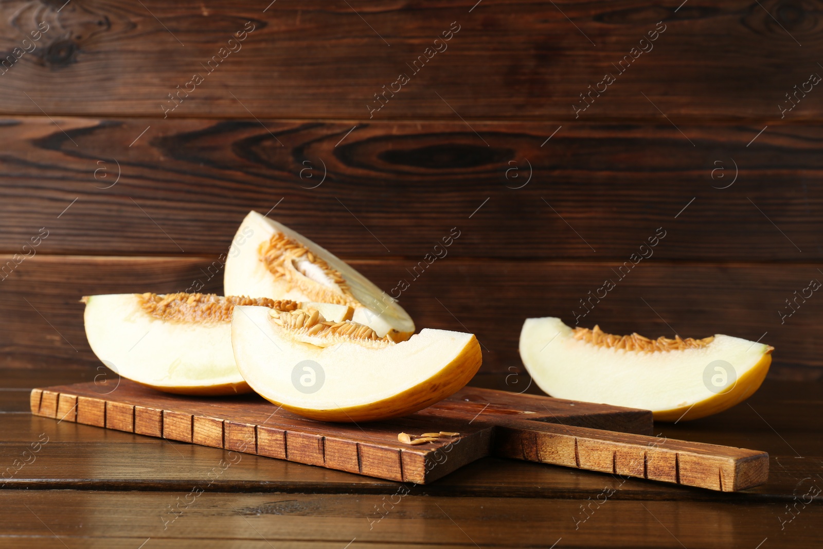 Photo of Cut fresh ripe melon on wooden table