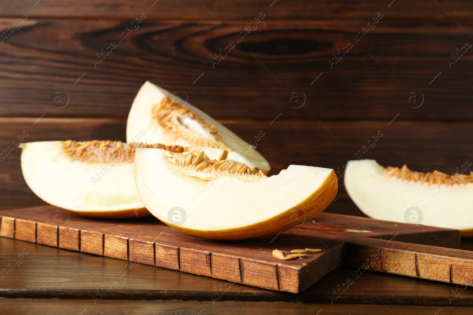 Photo of Cut fresh ripe melon on wooden table