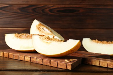 Photo of Cut fresh ripe melon on wooden table