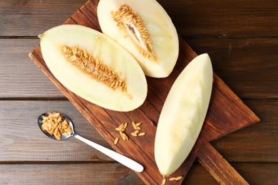 Cut fresh ripe melon on wooden table, top view