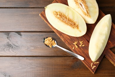 Cut fresh ripe melon on wooden table, top view. Space for text