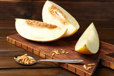 Photo of Cut fresh ripe melon on wooden table