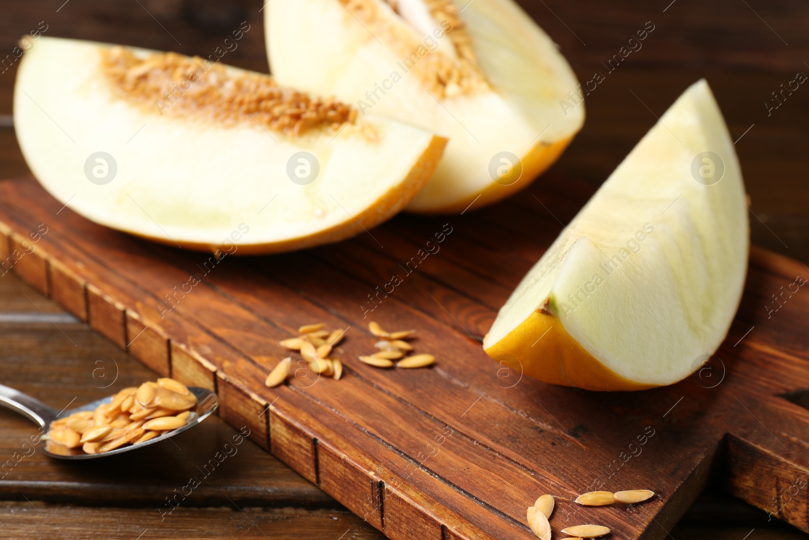 Photo of Cut fresh ripe melon on wooden table, closeup