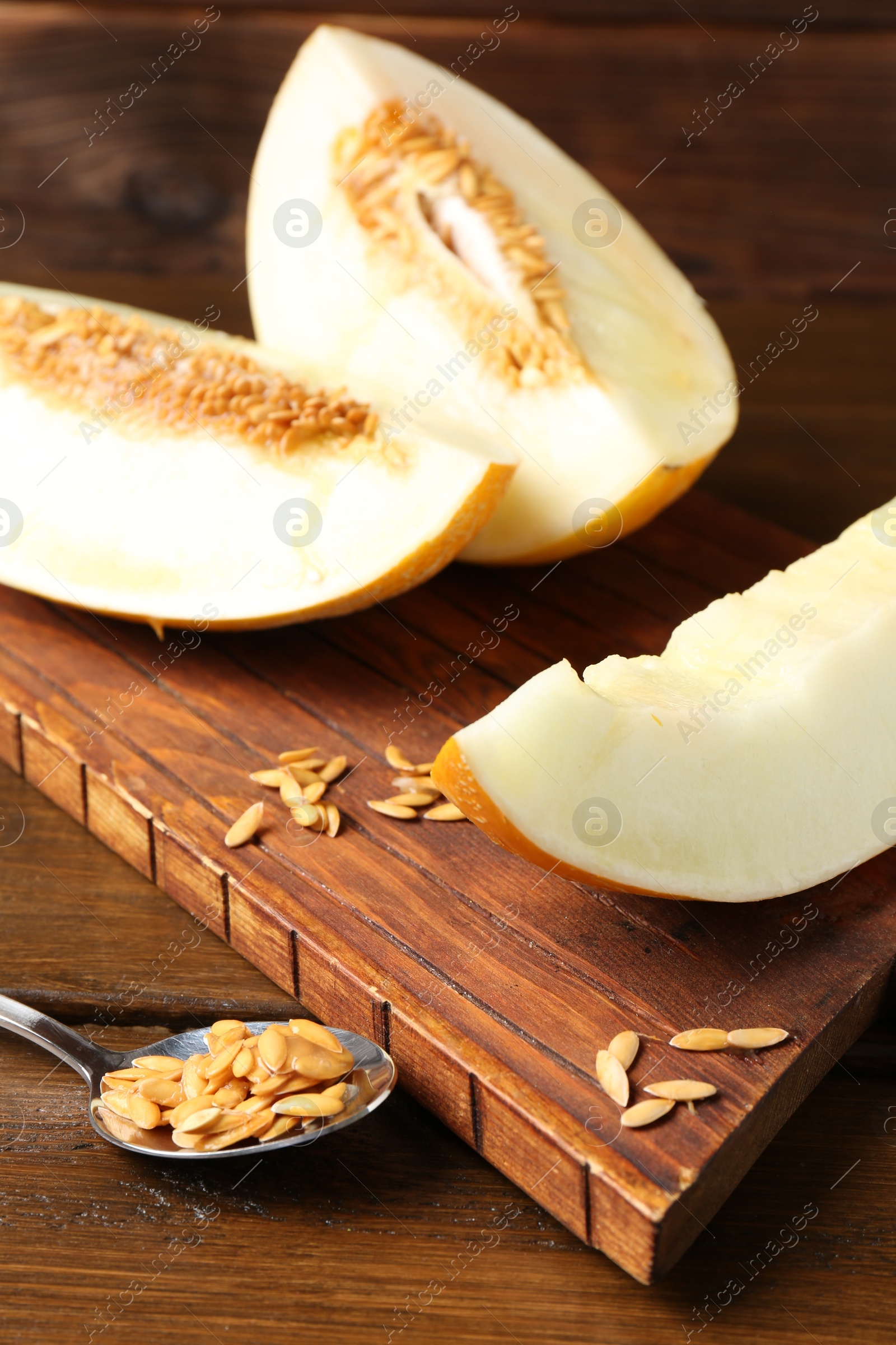 Photo of Cut fresh ripe melon on wooden table, closeup