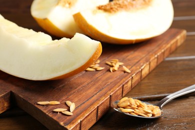 Cut fresh ripe melon on wooden table, closeup