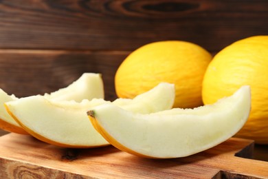 Fresh ripe melons on wooden table, closeup