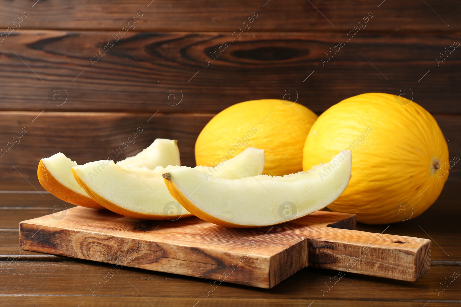 Photo of Fresh ripe melons on wooden table. Summer fruit