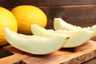 Fresh ripe melons on wooden table, closeup