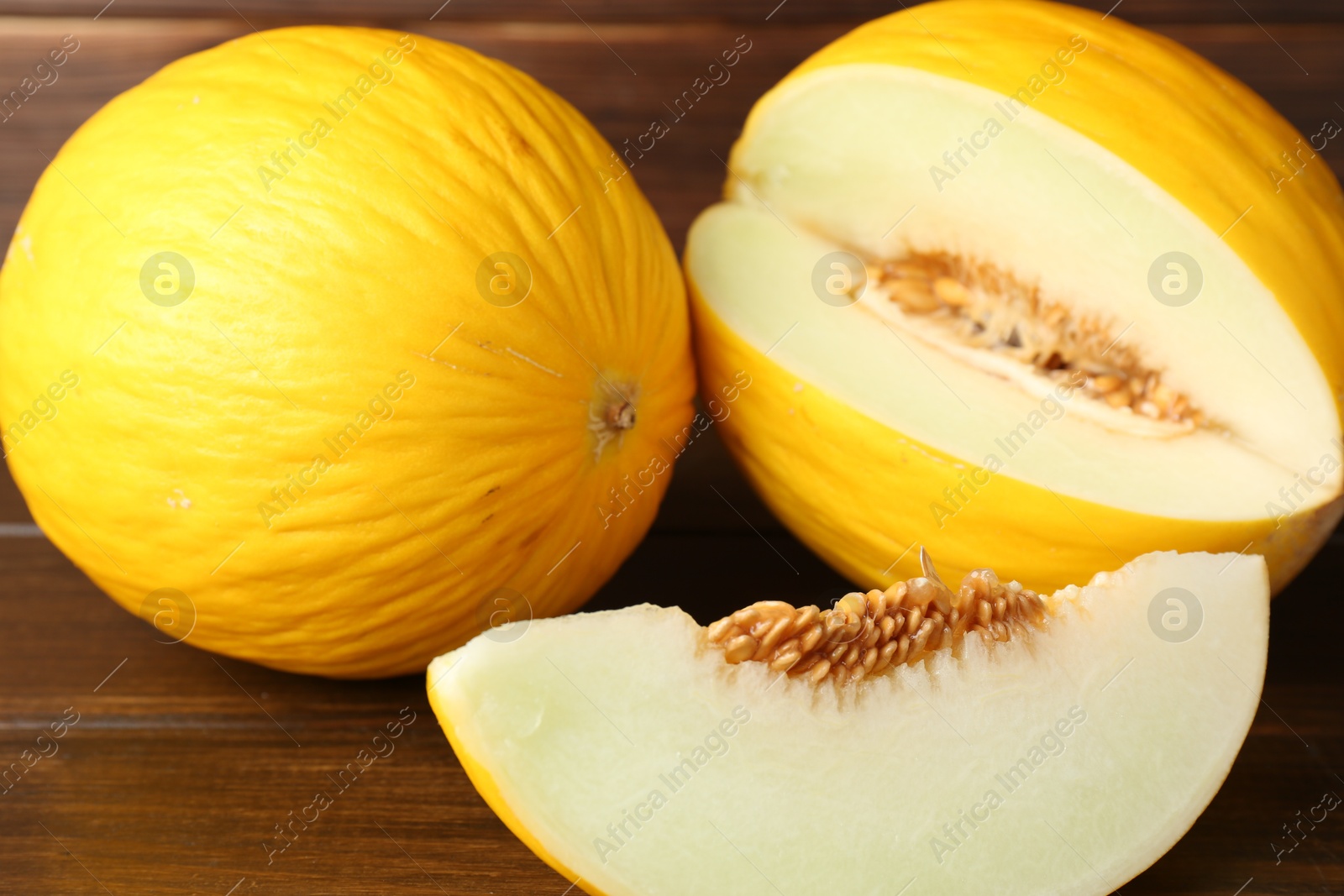 Photo of Fresh ripe melons on wooden table. Summer fruit