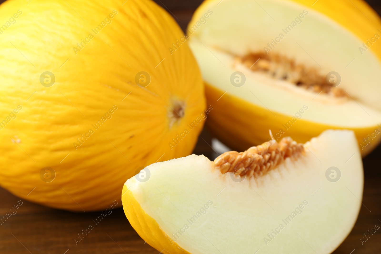 Photo of Fresh ripe melons on wooden table, closeup