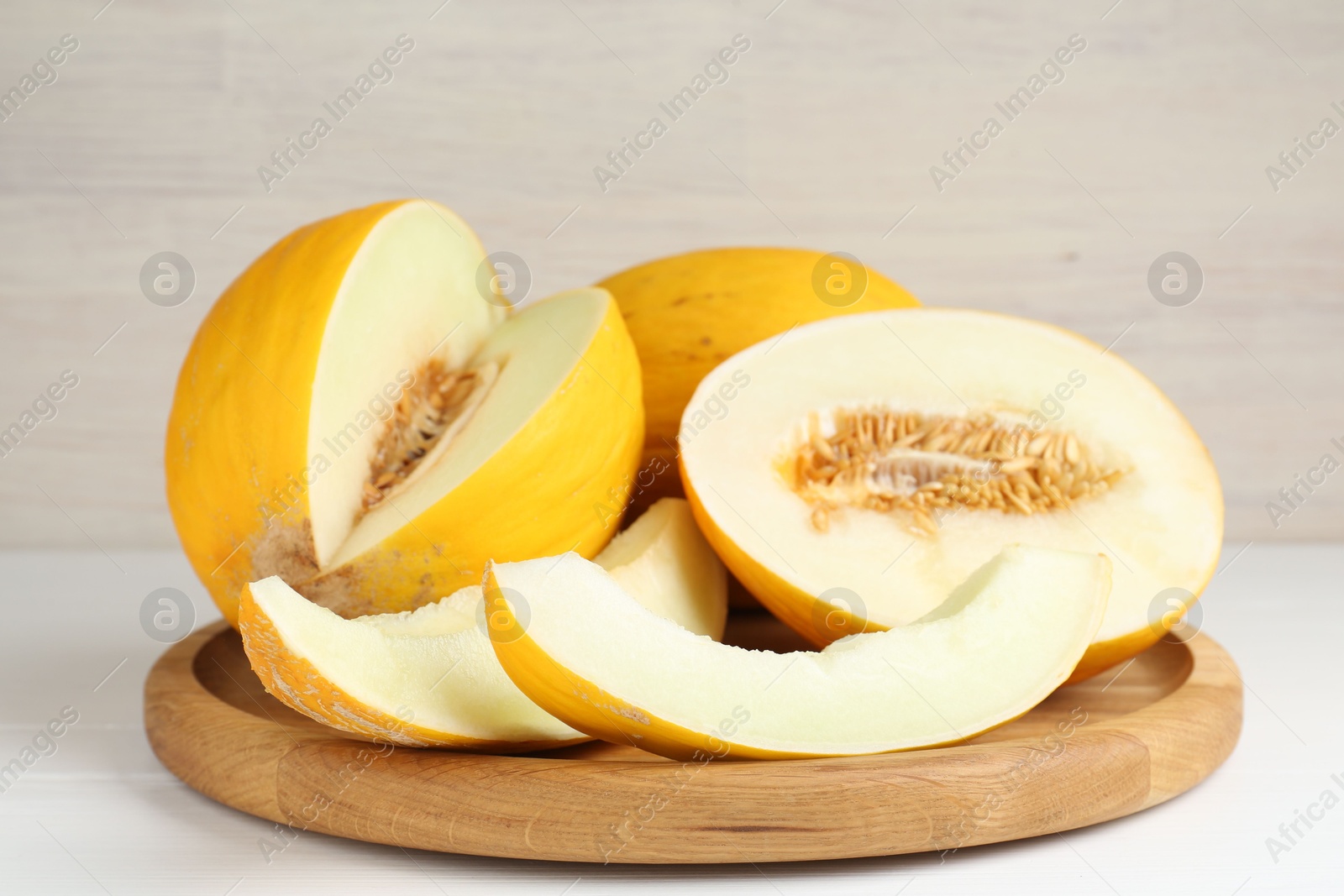 Photo of Fresh ripe melons on white table. Summer fruit